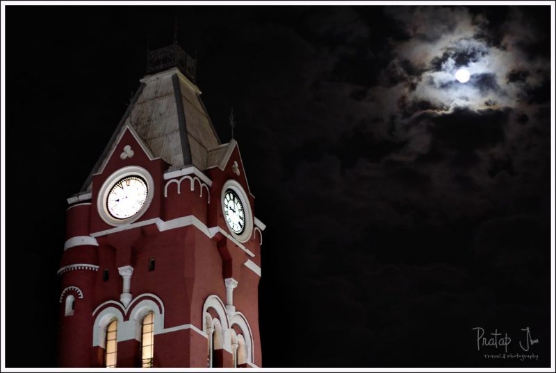 A full moon over the clock at Chennai Central Railway Station