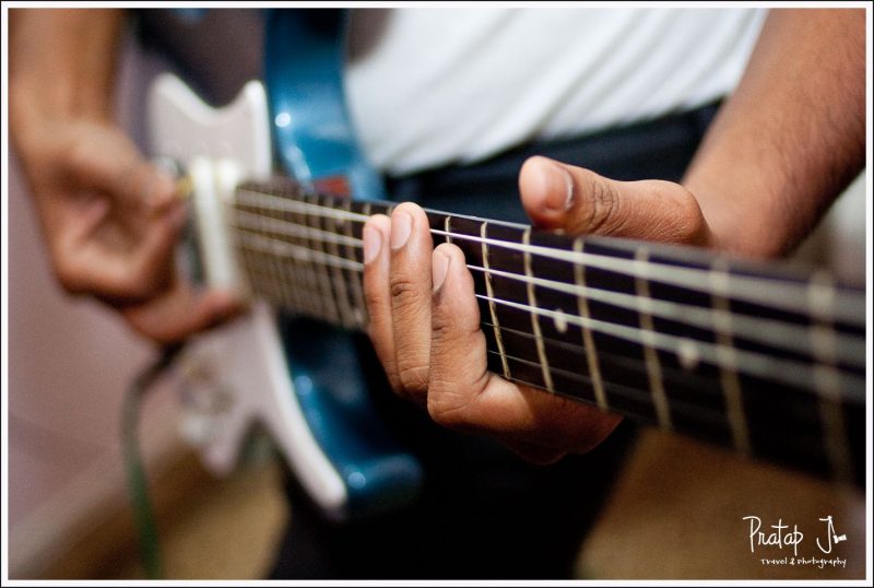 A photo of a man playing a guitar