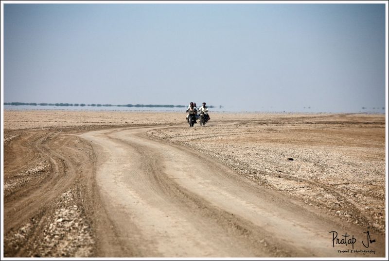 Locals riding bikes in Little Rann of Kutch