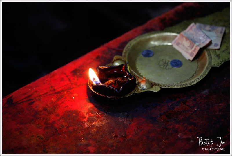 A photo of the flame in an aarthi inside a temple