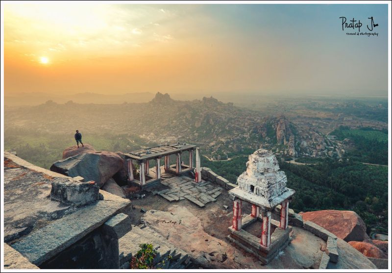 Man stands on a rock at Mathanga during sunrise