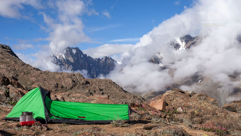 Green tent with Snow Clad Peaks